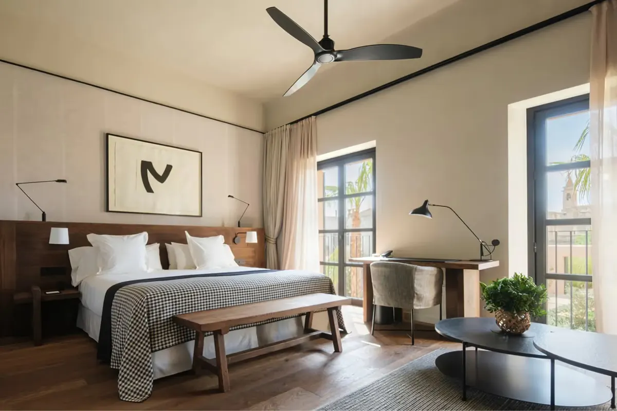 Guest bedroom with neutral palette and large windows