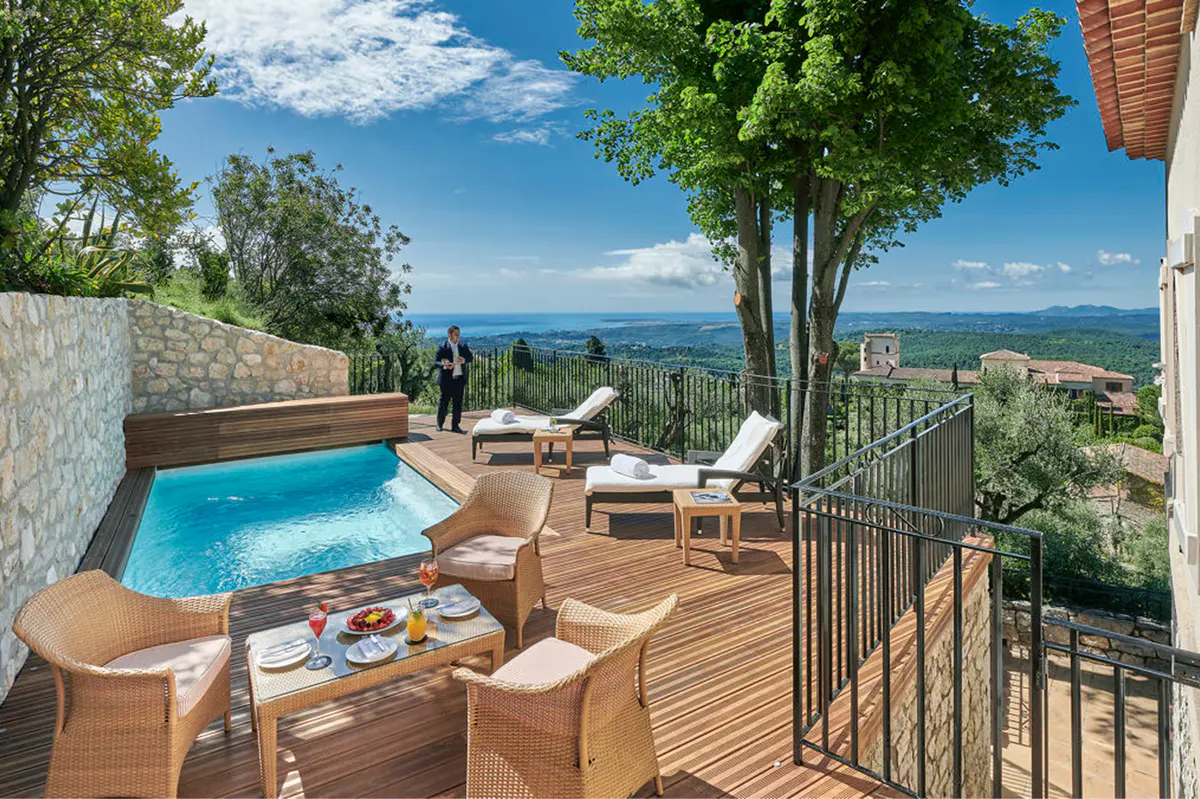 Infinity pool overlooking olive groves with mountain vistas beyond