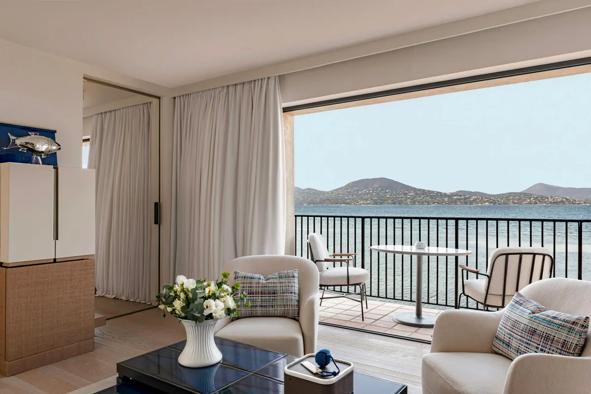 Sitting area with seating chairs and terrace overlooking bay
