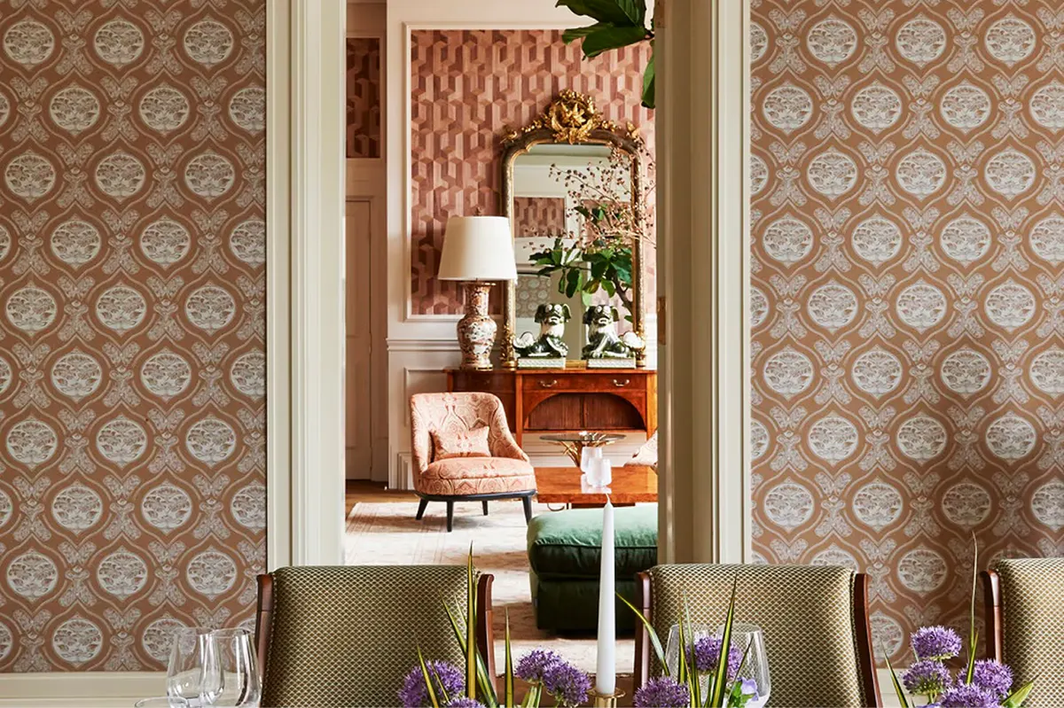 Lounge interior with patterned wallpaper, warm lighting, and elegant furnishings