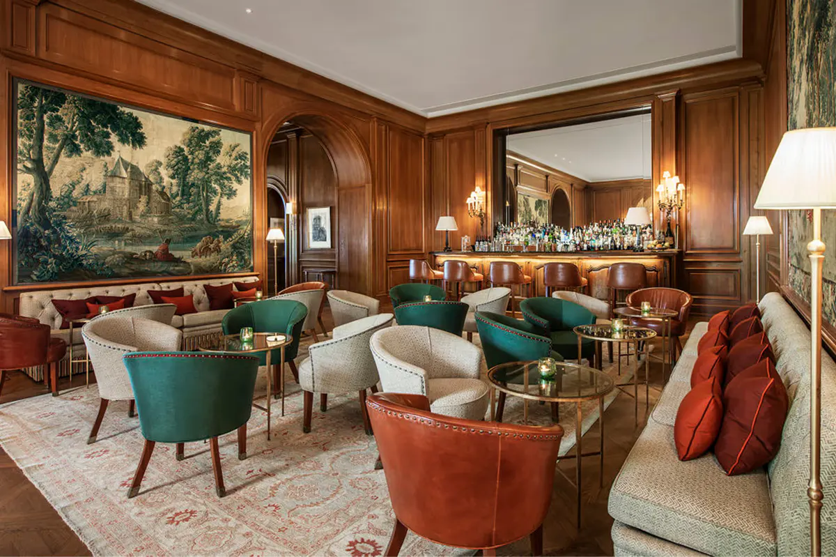 Wood-paneled bar and lounge with turquoise and coral upholstered seating