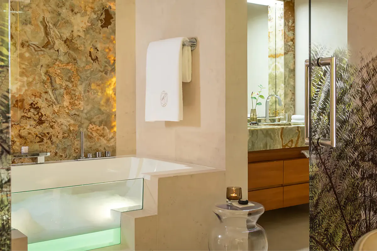 Spa bathroom with stone features and illuminated accent wall