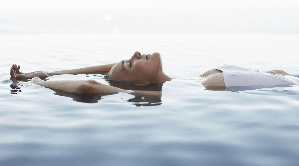 Person floating in an outdoor thermal pool