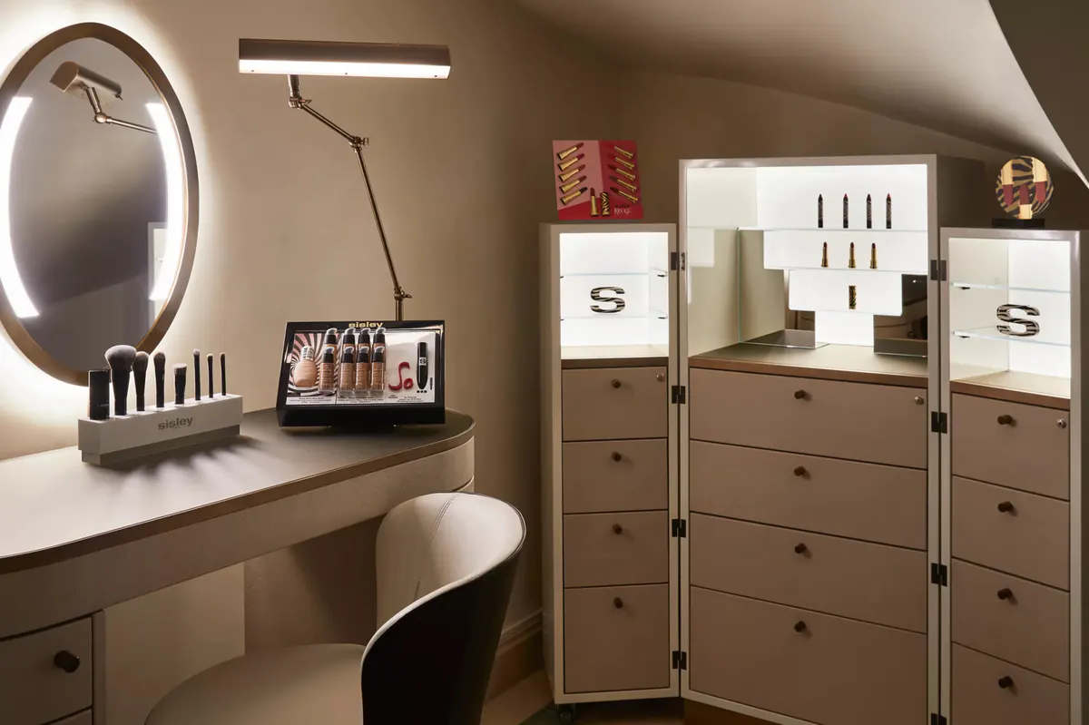 Spa dressing room with three-panel mirror and organized storage cabinetry
