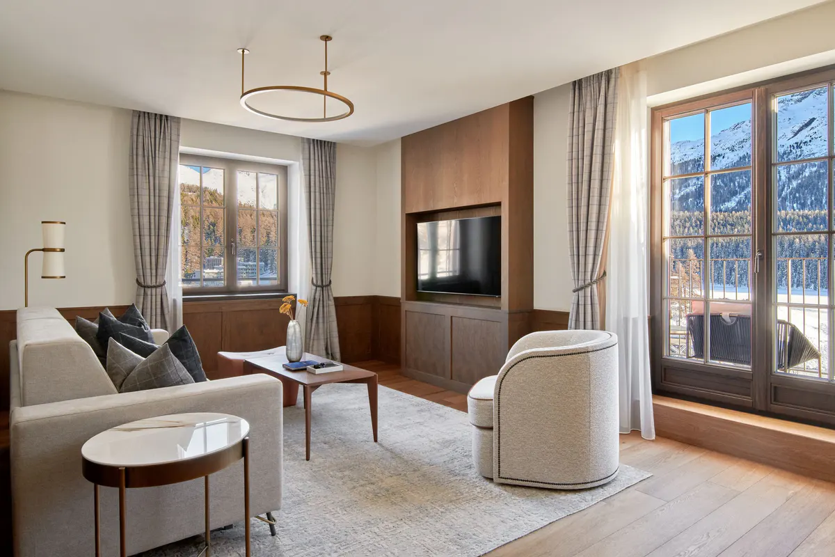 Sitting room with wood paneling, upholstered seating, coffee table, and mountain views