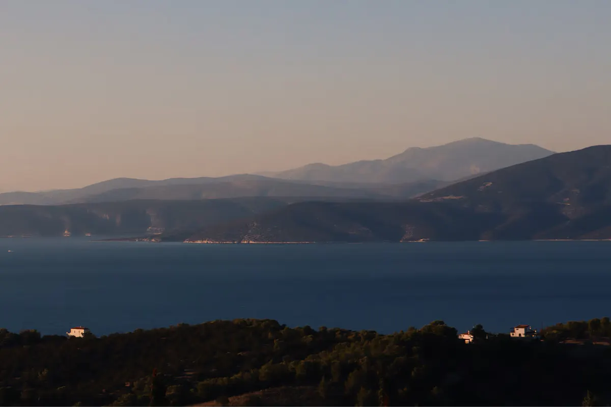 Twilight view of the water with distant resort lights