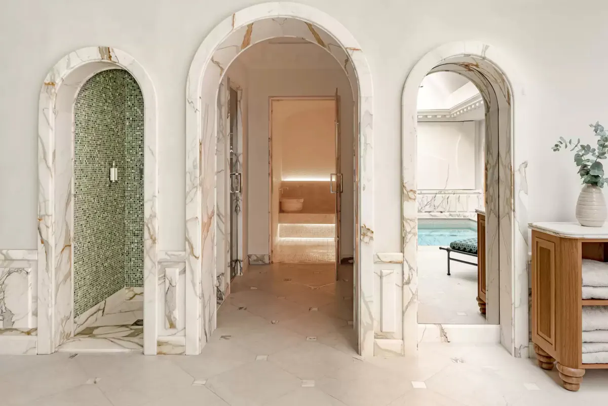 Classical corridor with arched marble doorways and natural light