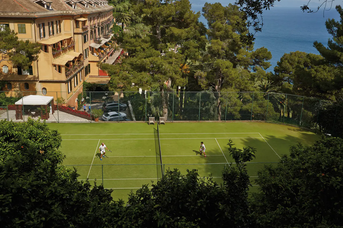 The hotel grounds with manicured lawn overlooking the sea and terraced gardens