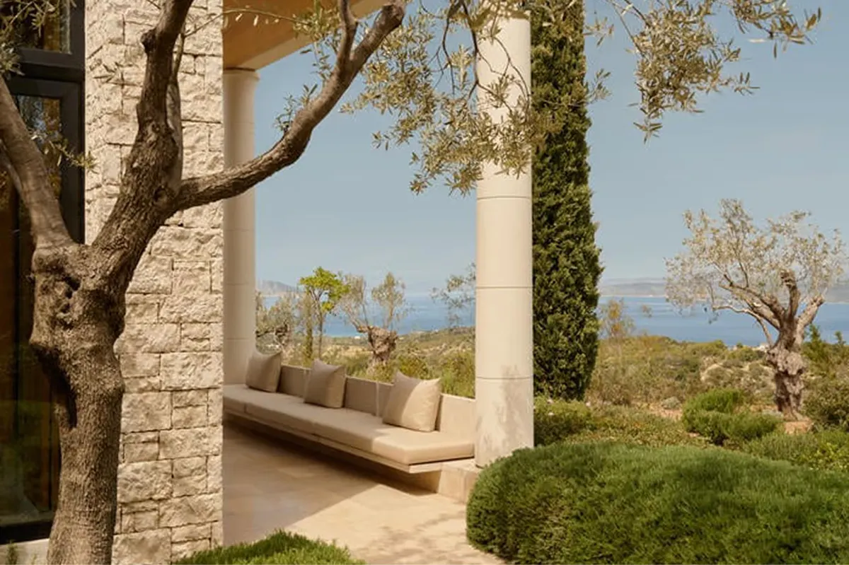 Columned structure with lounge chairs facing seascapes and distant islands