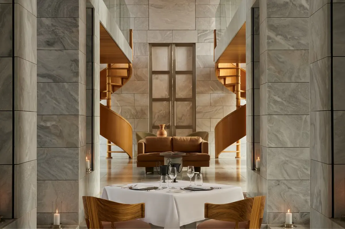 Minimalist restaurant with white tablecloths and symmetrical plaster columns