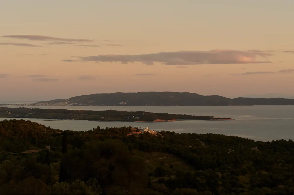 Dusk landscape showing bay waters and forested shoreline