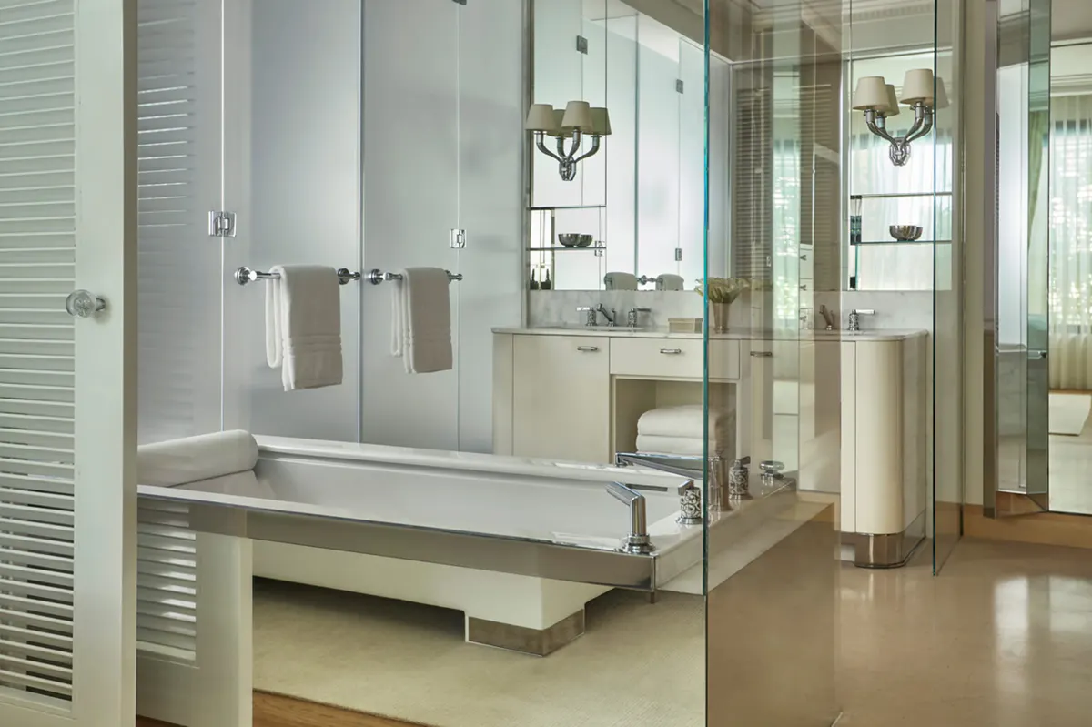 Modern marble bathroom suite with dual vanity and walk-in shower