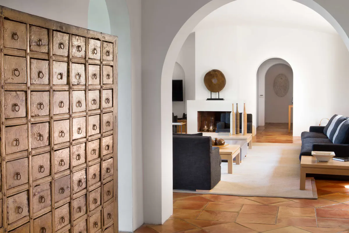 Light-filled interior with arched doorway and minimalist furnishings