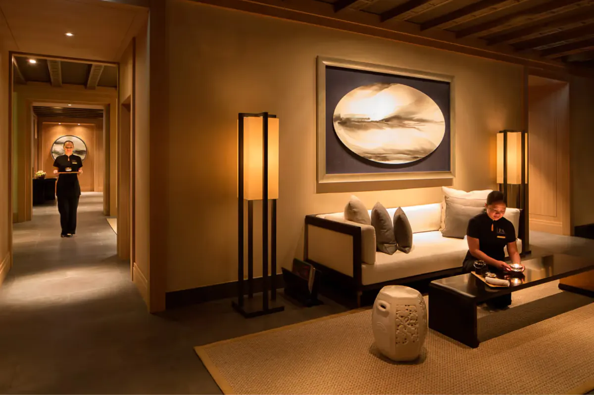 Spa treatment room with neutral palette, bench seating, and focused overhead lighting