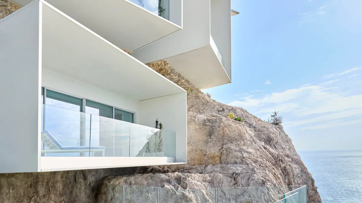 Modern architecture cantilevered over a rocky outcrop