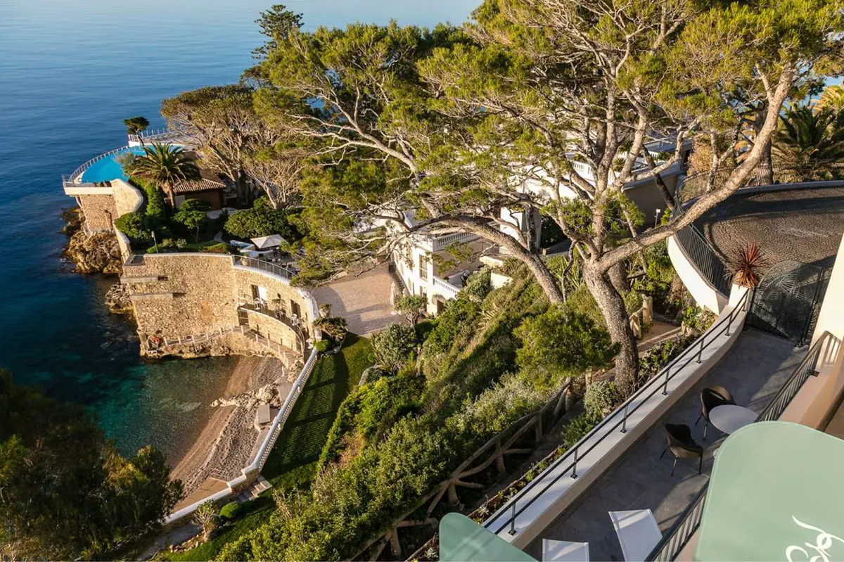 Terraced balconies and structures descending to a private beach cove