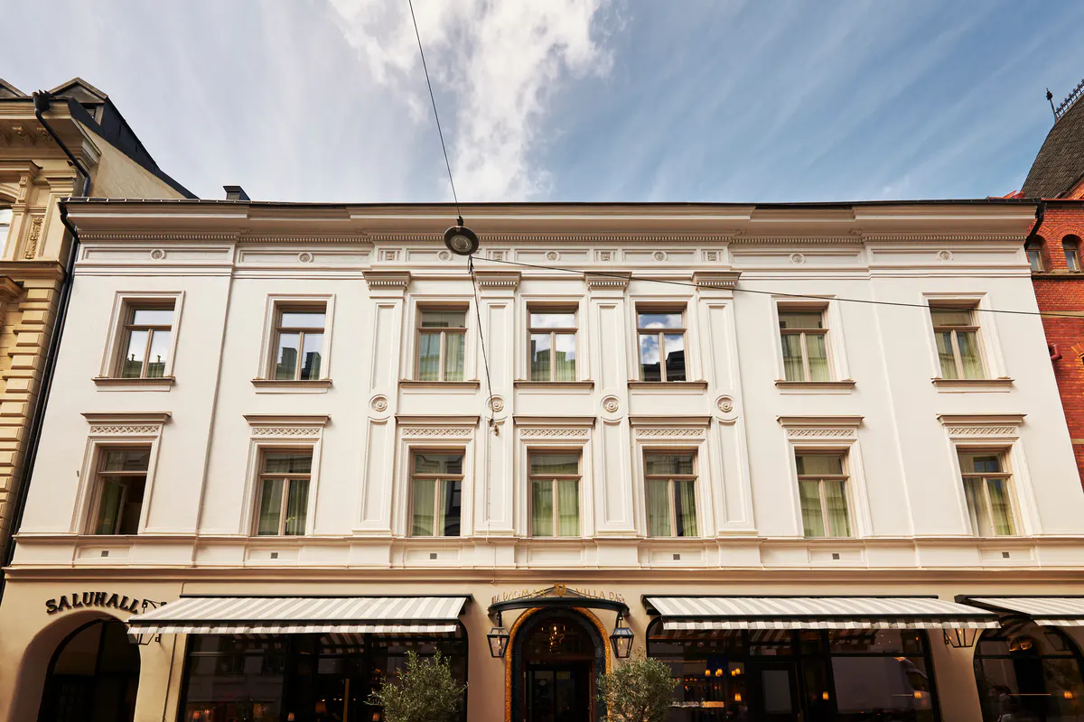 Classic European building facade with regular fenestration and ground-floor retail