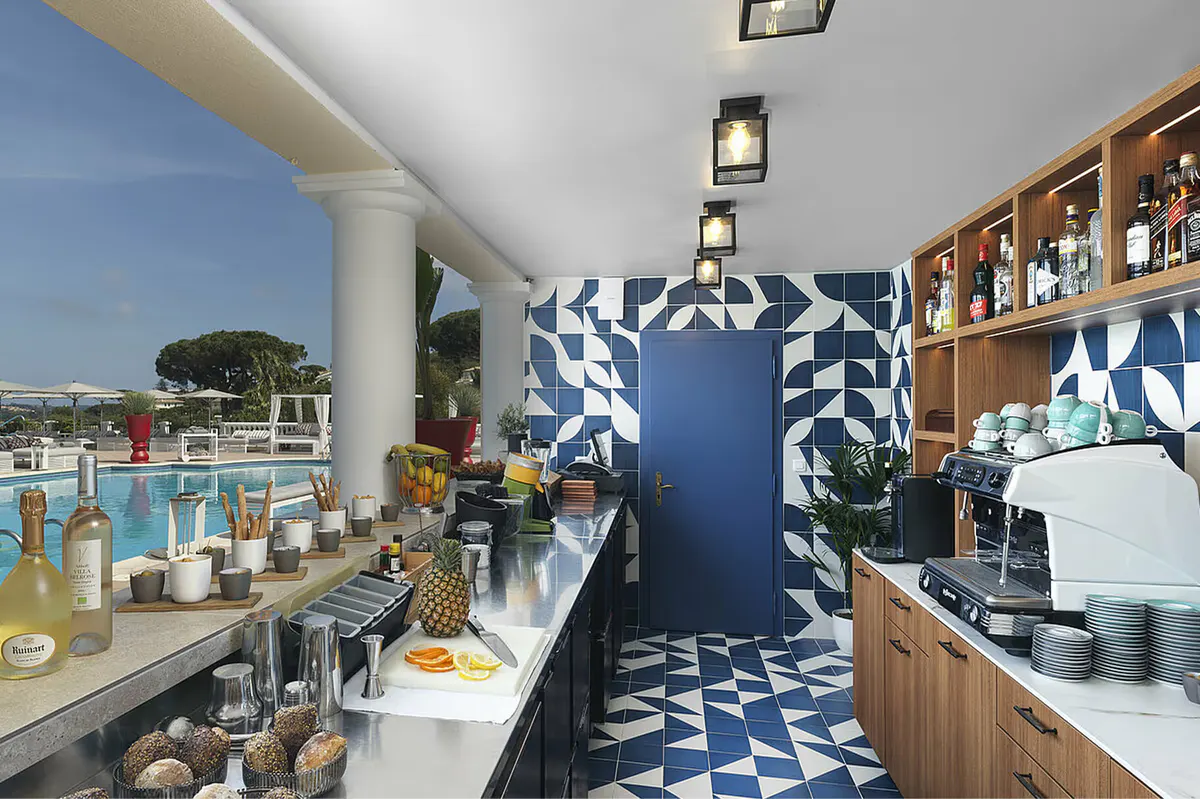 Nautical-blue bar area with polished service counter and geometric floor
