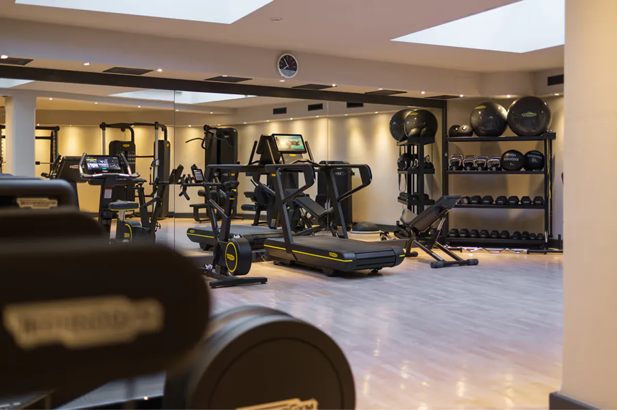 Fitness center with exercise equipment and bright natural lighting
