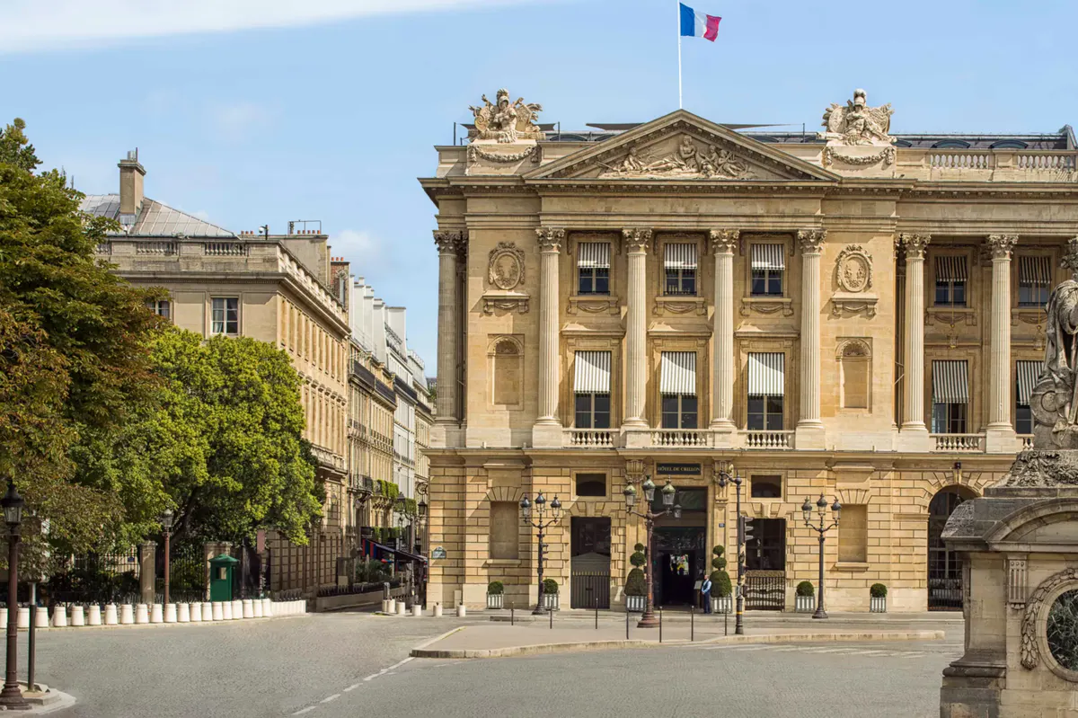 Grand 18th-century facade with classical columns and French flag, Place de la Concorde