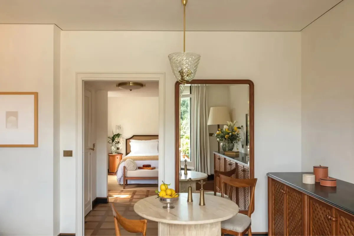 Suite with round mirror, seating, and harbor view