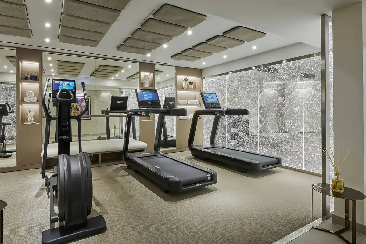 Fitness center with cardio equipment and bright interior