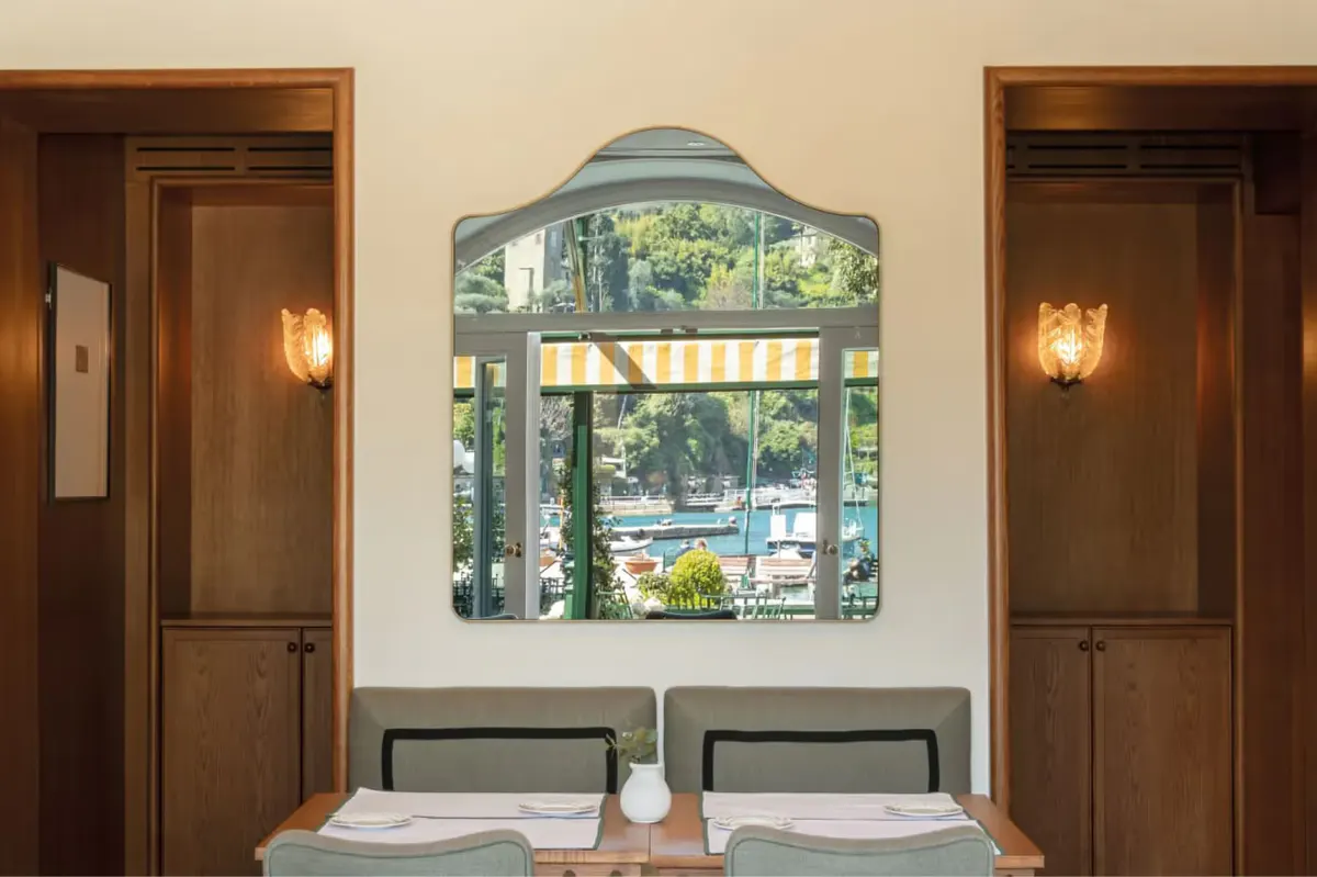 Dining room mirror overlooking harbor with bench seating