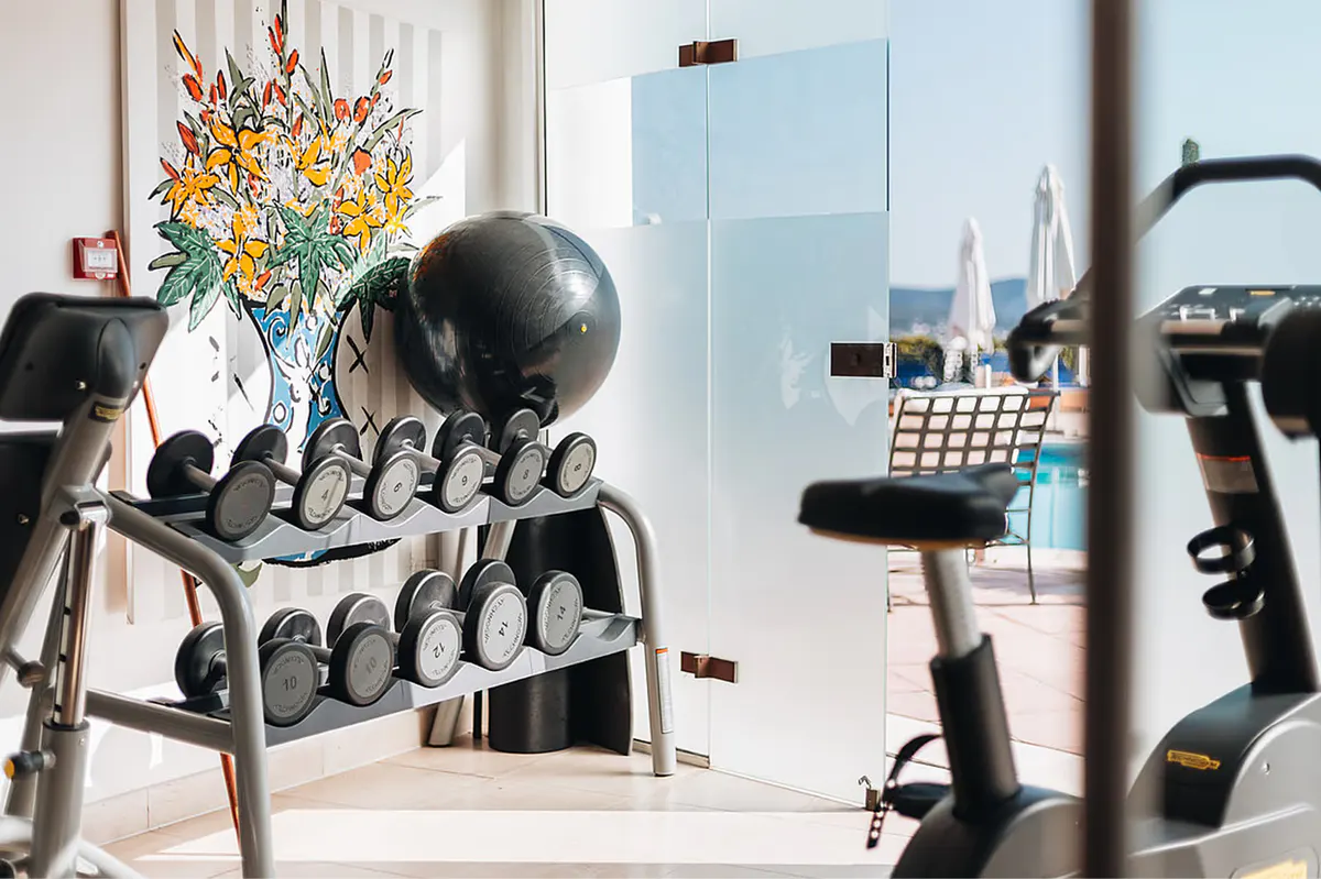 Fitness studio with floor-to-ceiling windows and strength training equipment
