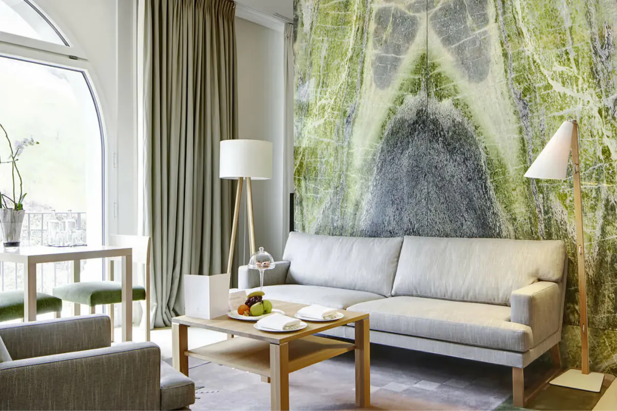 Lounge with large nature landscape wall mural and pale furniture