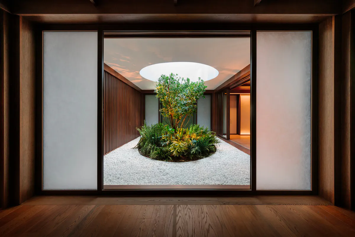 Modern spa treatment room with recessed lighting, natural skylight, and serene minimalist design