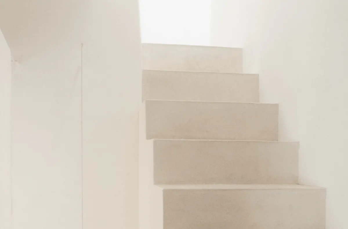 Architectural staircase with recessed steps and soft natural light from above