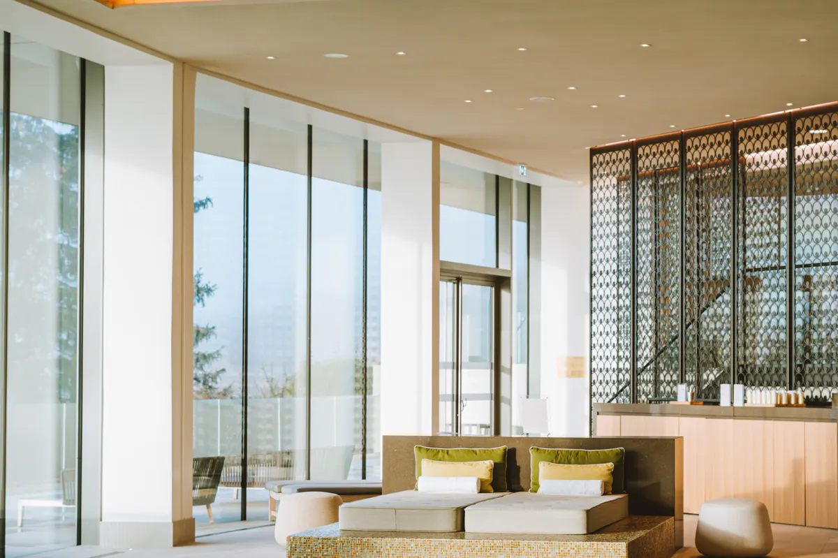 Wellness suite with seating area and large windows with mountain valley views