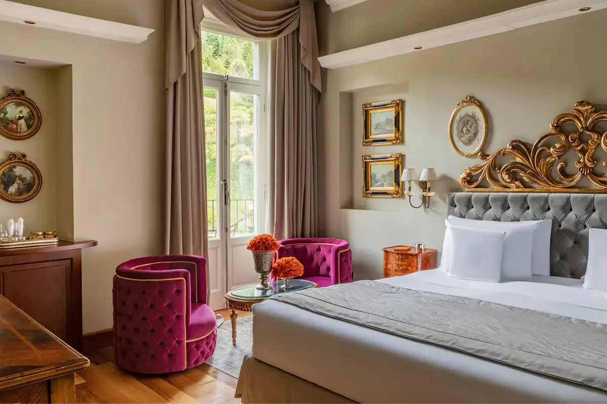 Bedroom with burgundy armchair, taupe furnishings, and green window trim