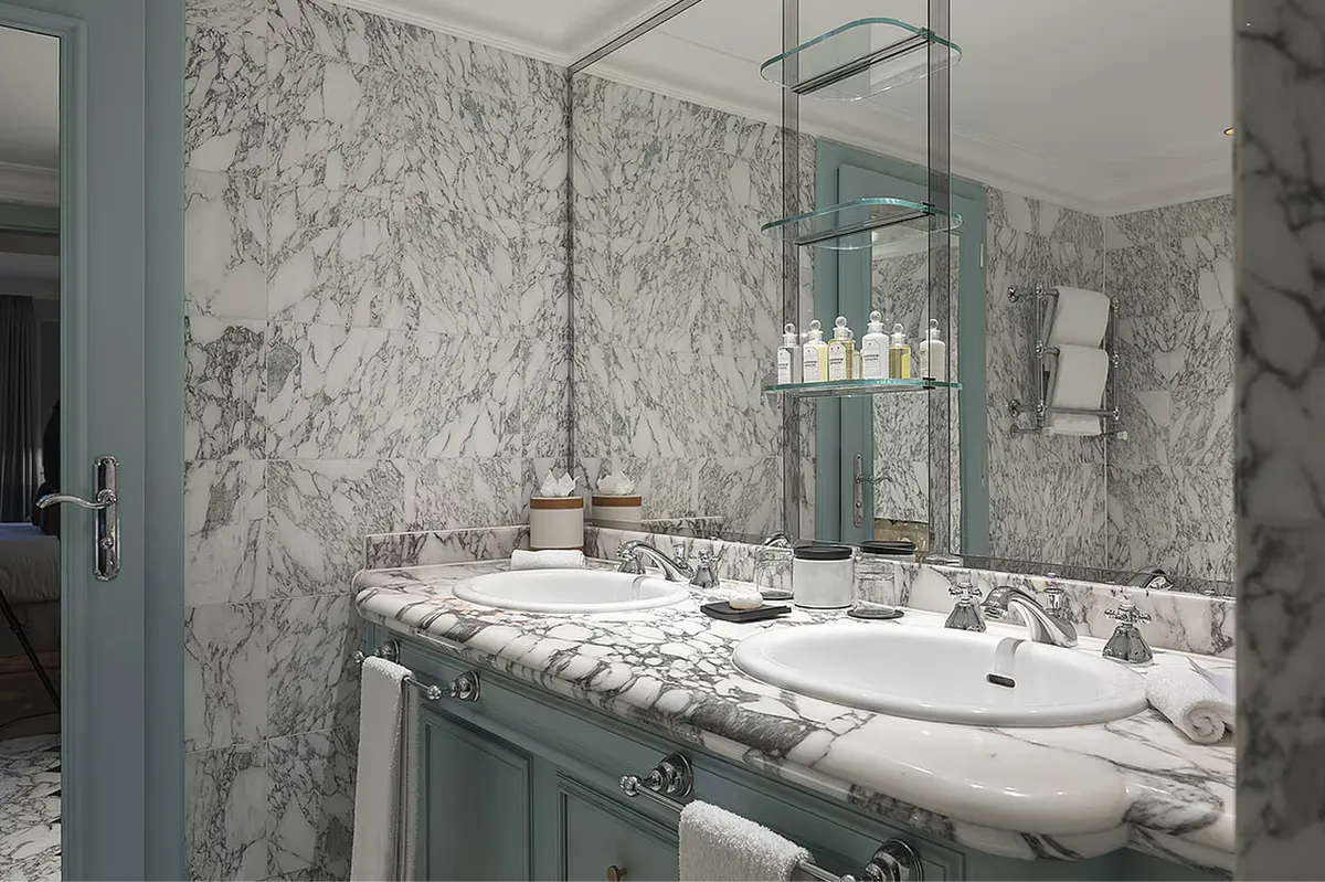 Marble-clad bathroom with vanity and picture window