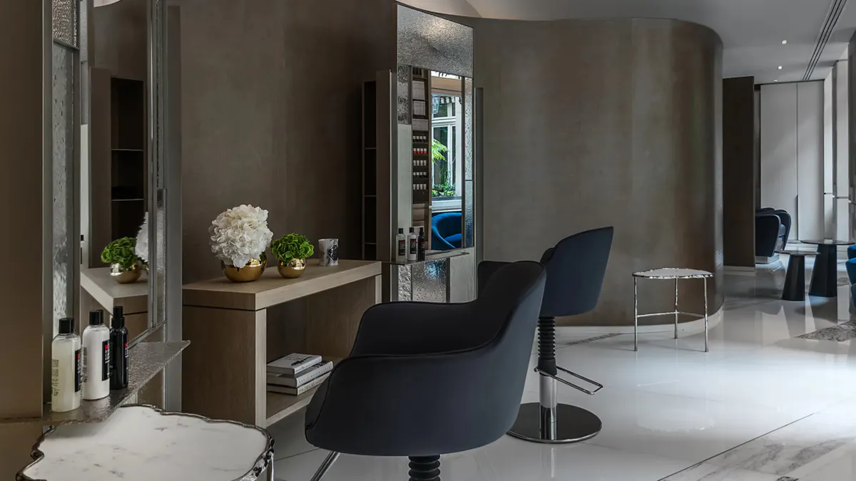 Spa vanity with round mirror and personal care amenities displayed