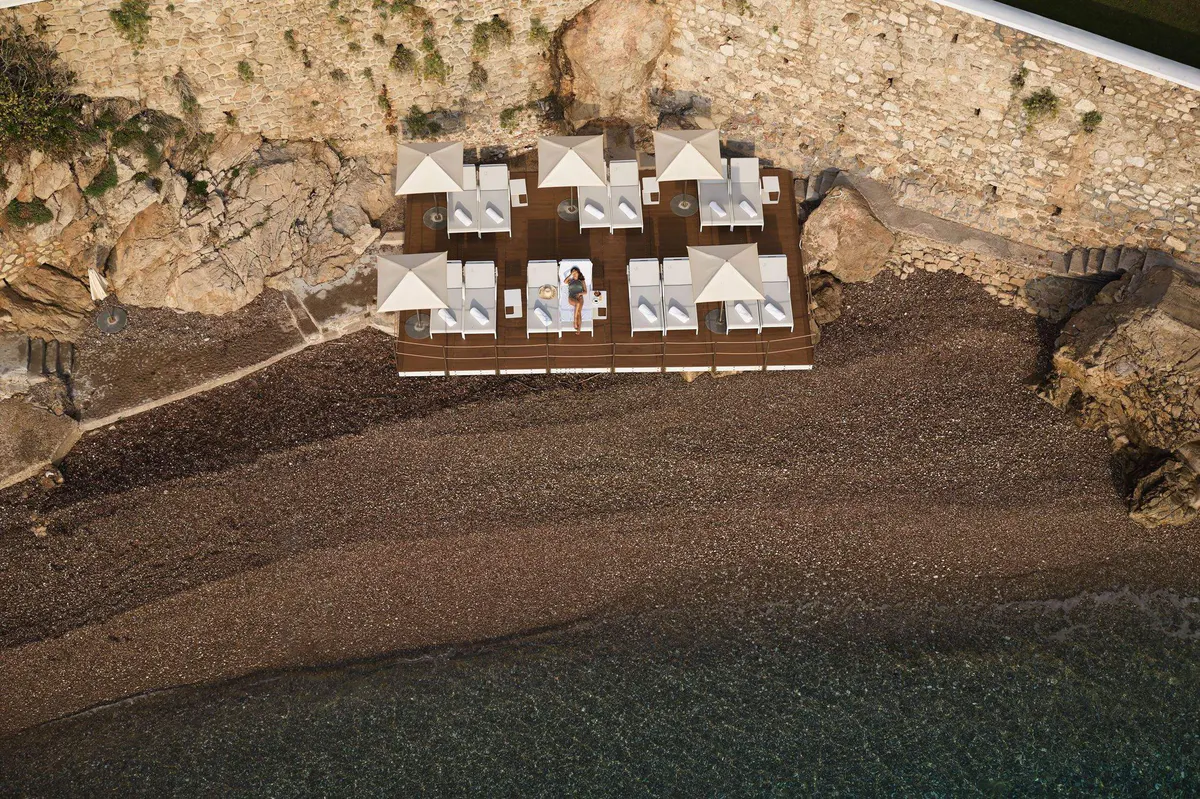 Loungers and seating arranged on a private sandy beach