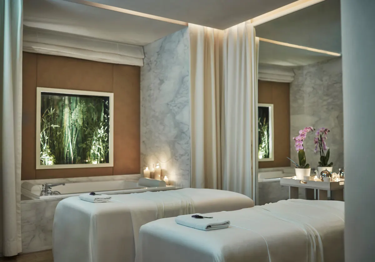 Spa treatment room with twin massage beds and soft lighting
