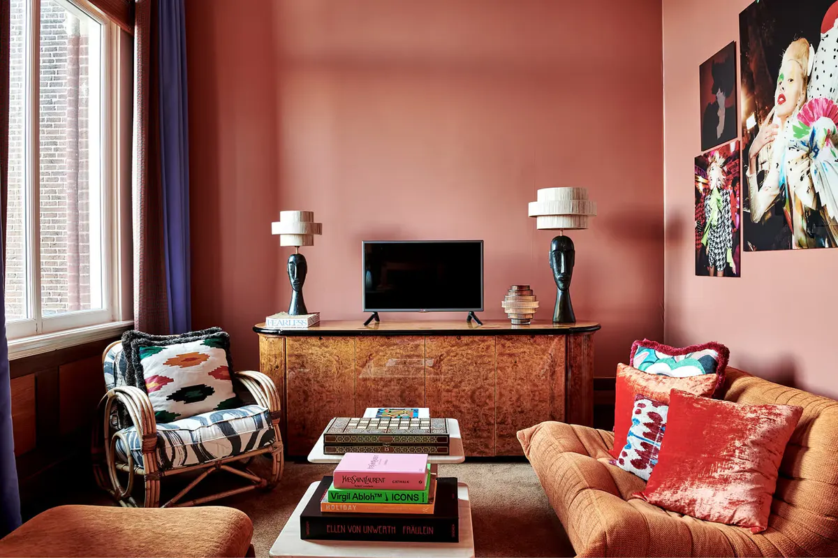 Corner suite with warm brown walls, patterned upholstery, and compact seating arrangement