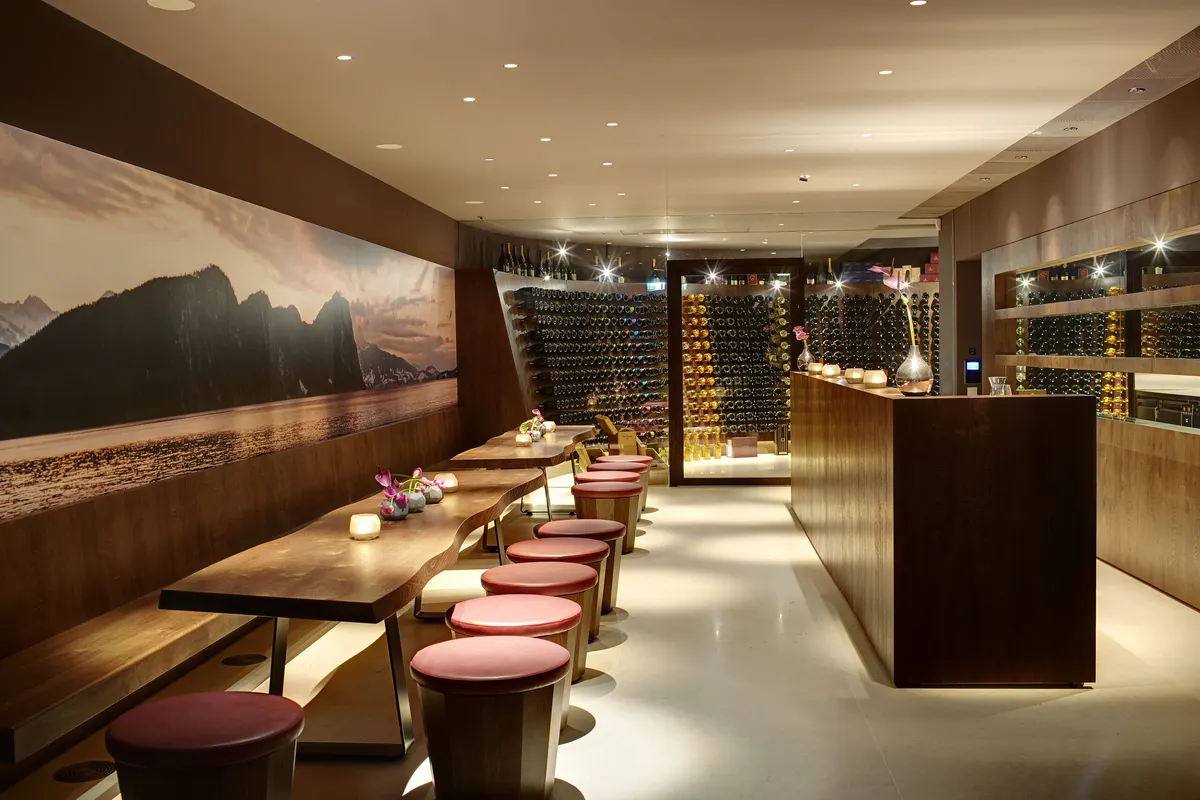 Fine dining room with dark finishes, mountain photography, and ambient lighting