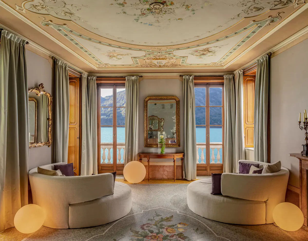 Spa lounge with arched doorways, draped fabrics, and lake views