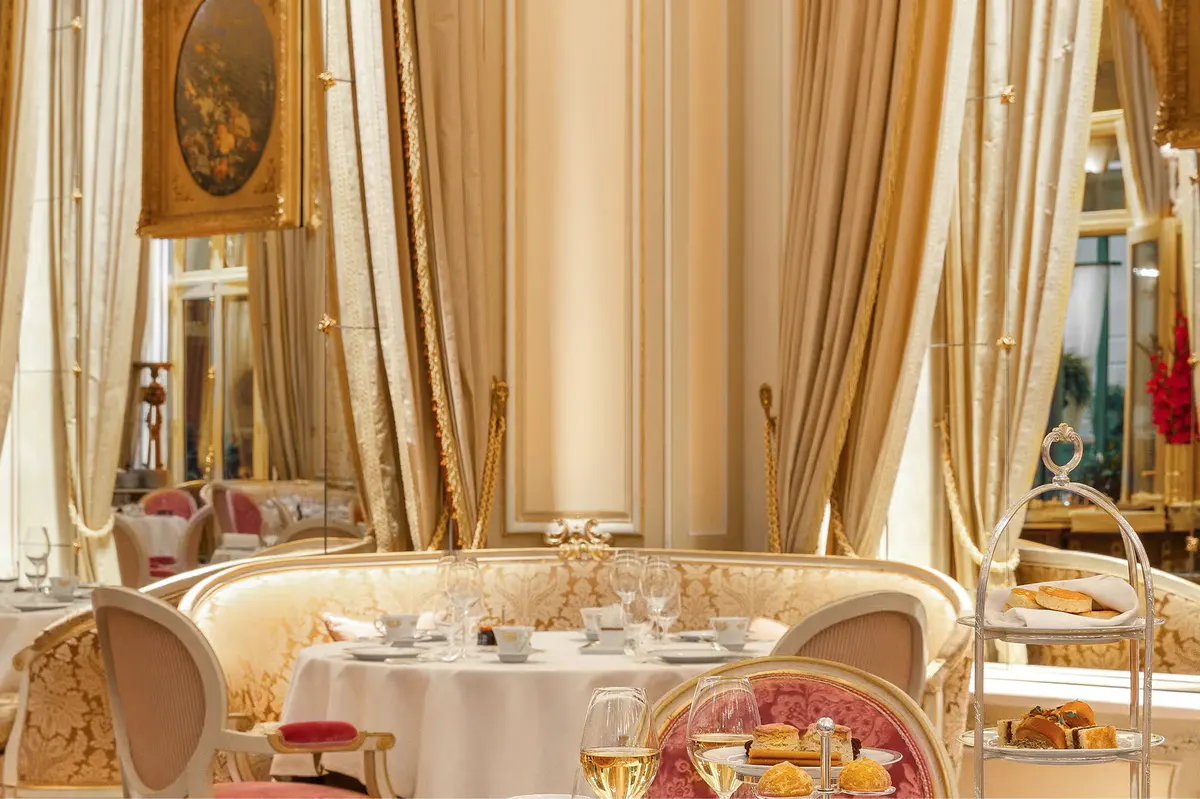 A breakfast service with chef in white toque, silver warming dome, and panoramic window views