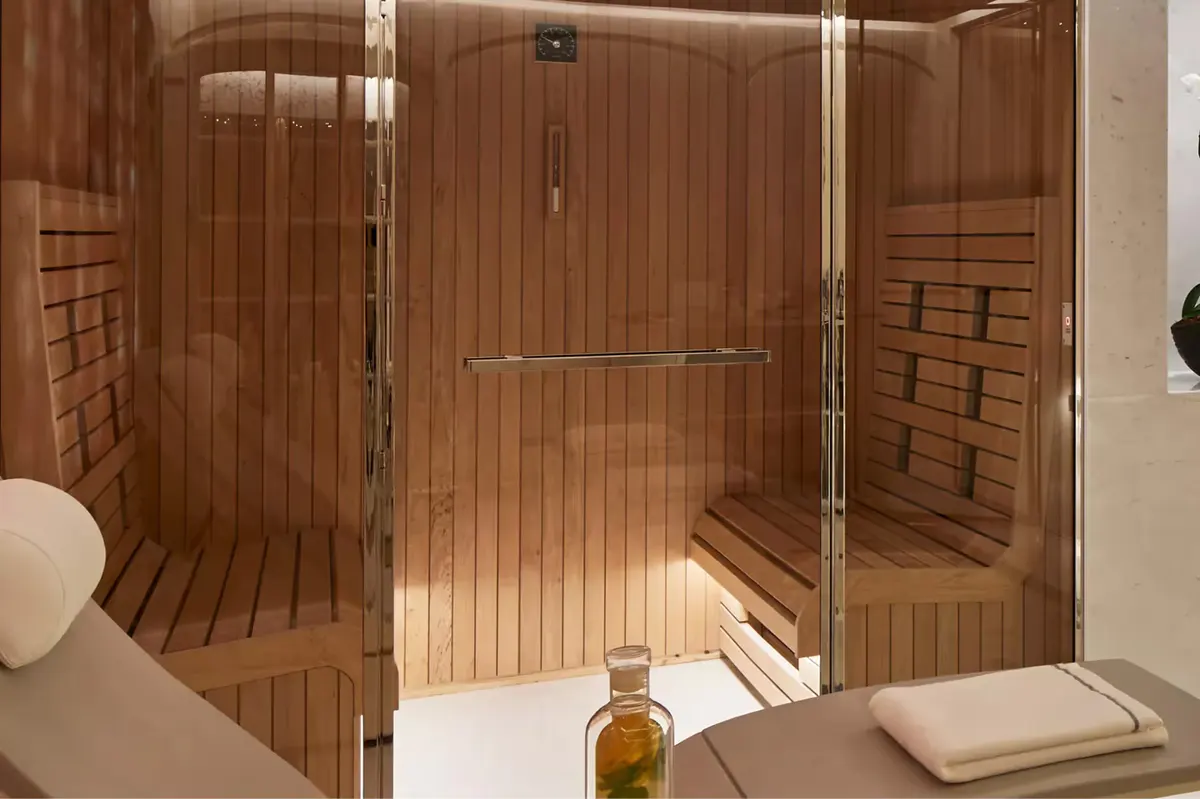 Spa relaxation area with white beds and soft architectural lighting