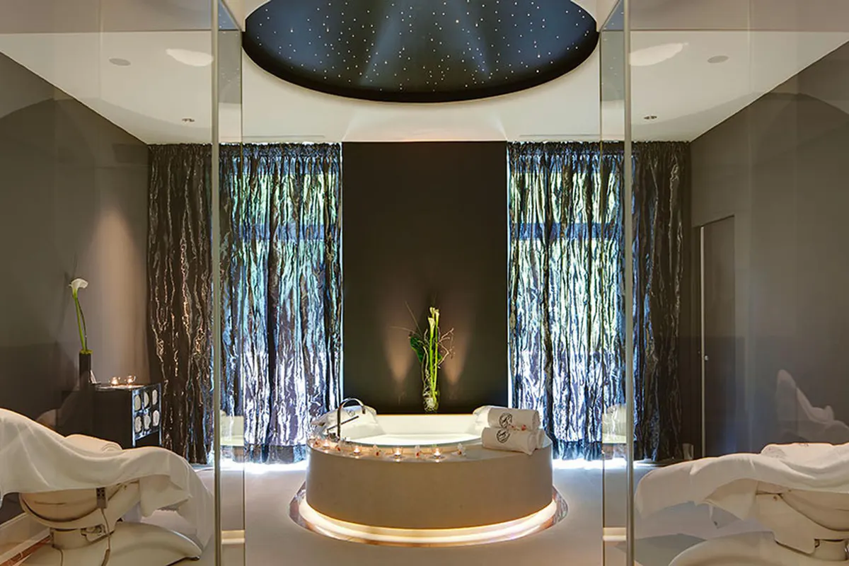 Spa treatment room with floating basin and cascading water feature