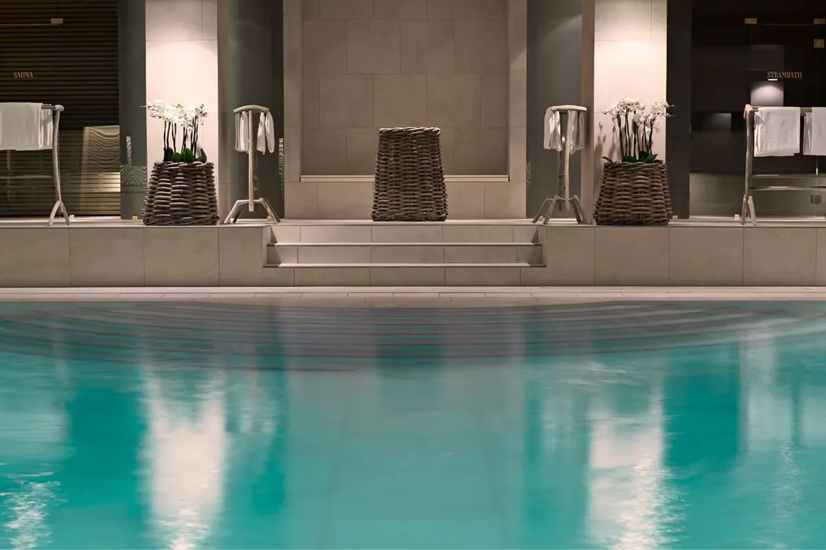 Indoor pool with turquoise water and vaulted ceiling in spa area