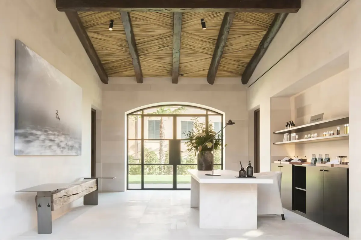 Spa reception with modern white cabinetry and wooden barrel ceiling