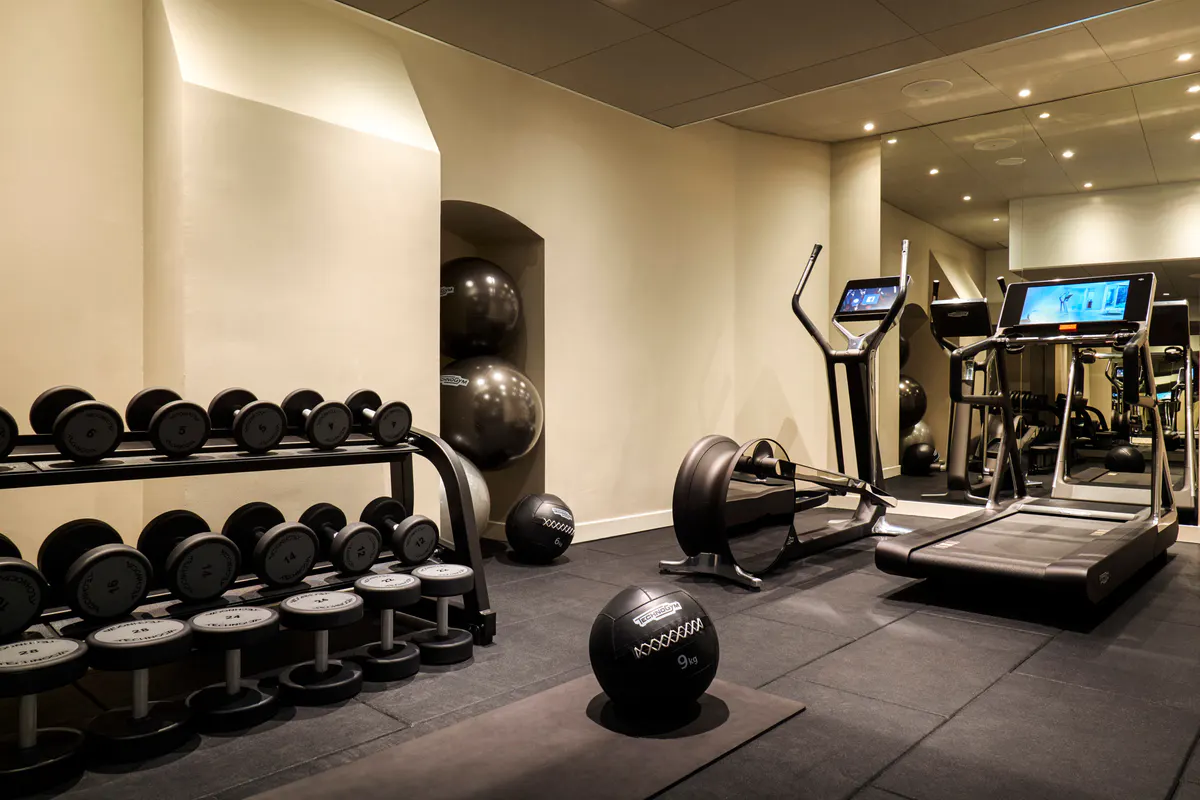 Fitness center with dumbbells, cardio equipment, and exercise machines