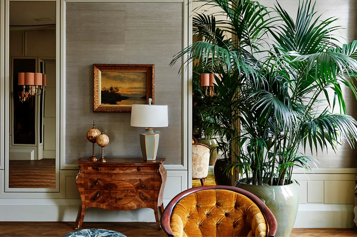 Foyer with botanical arrangement, wood furniture, and architectural detailing