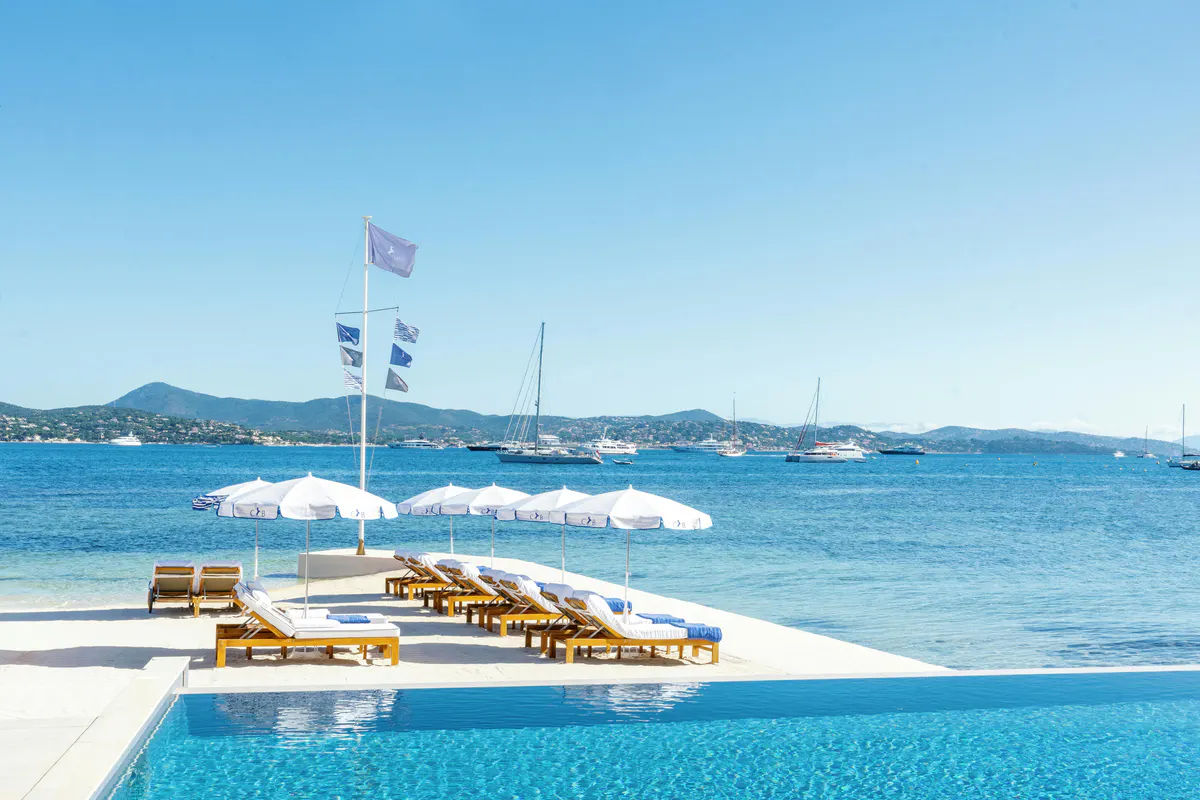 Infinity pool overlooking Mediterranean with distant shoreline