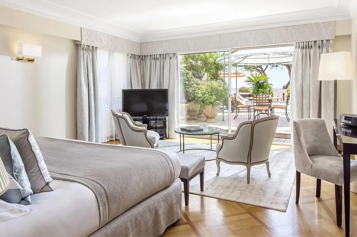 Bedroom opening onto a private terrace with sea views and lounging area