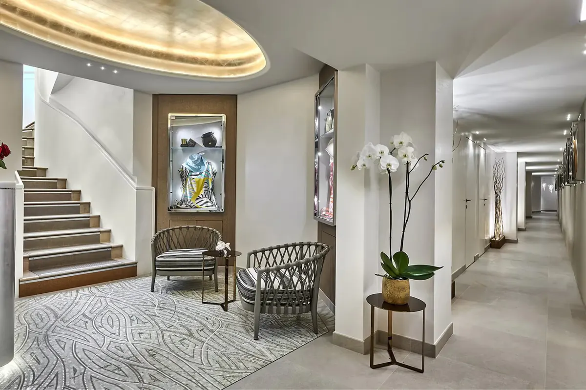 Hotel lobby with curved staircase and classical architecture